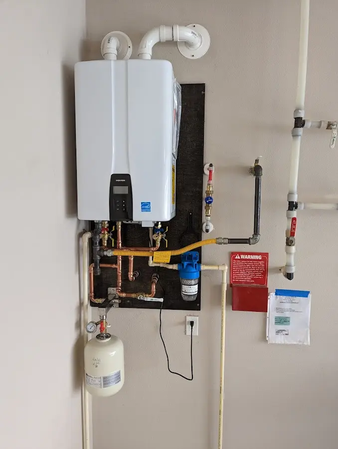 Professional plumber installing copper piping in a Point Pleasant Beach home